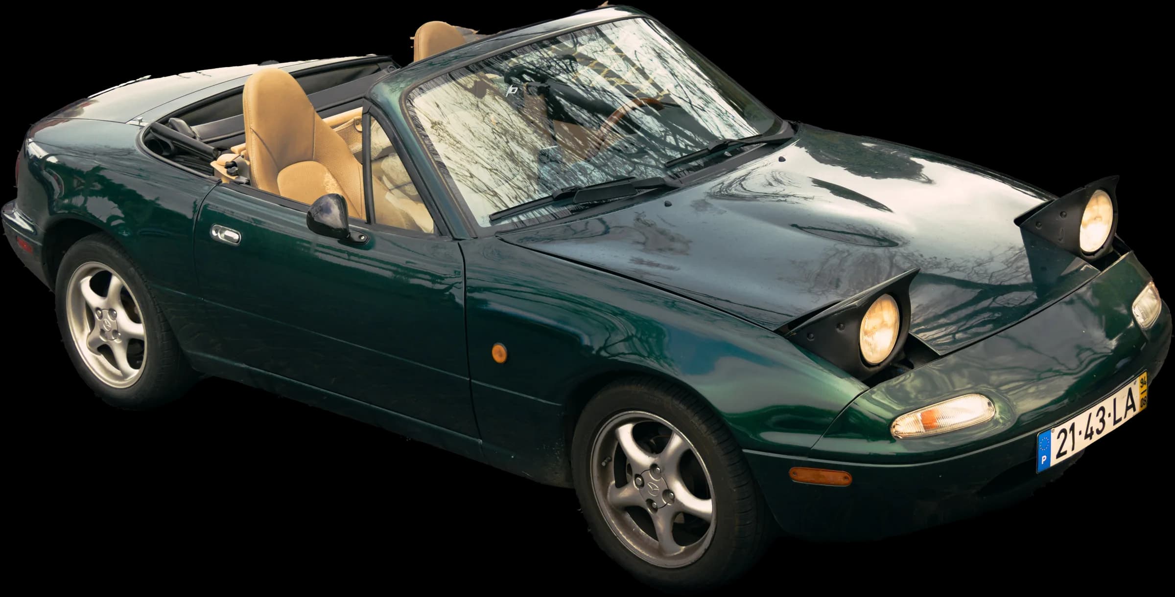 Mazda MX-5 de 1994 verde escuro, de três quartos, com os faróis pop-up levantados